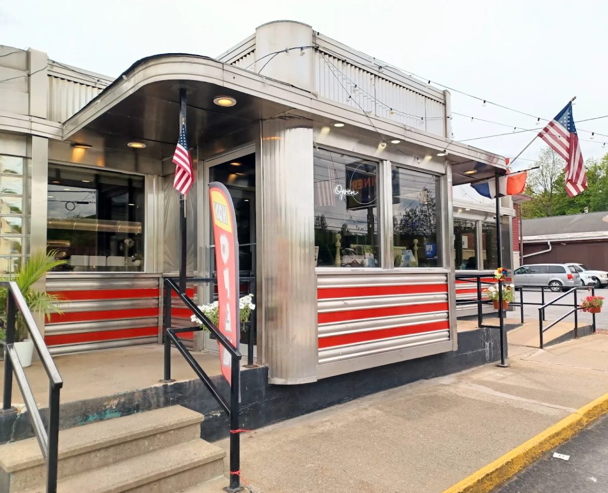 The stainless-steel Walton Diner on Delaware Street, with red stripes along the front and a curved steel canopy over the entrance
